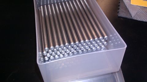 1996 Ford Bronco - A clear plastic container holds many identical metal rods arranged in rows.
