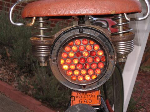 1994 Ford Bronco - Custom motorcycle tail light assembly a cluster of red lights and a vintage license plate.