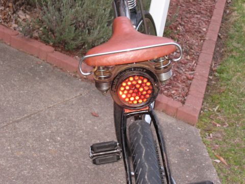 1994 Ford Bronco - Custom bicycle tail light assembly with a vintage-style brown seat.
