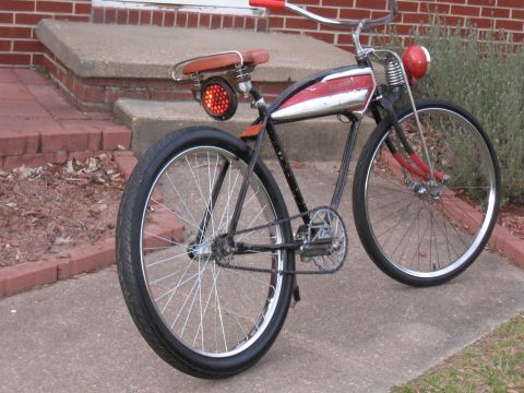 1994 Ford Bronco - A vintage bicycle with a unique red taillight and chrome detailing sits on a concrete path.