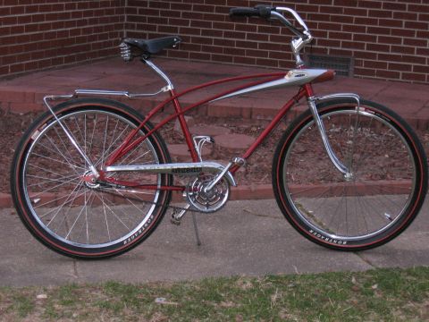 1994 Ford Bronco - A red bicycle with chrome fenders and handlebars sits on a concrete path.