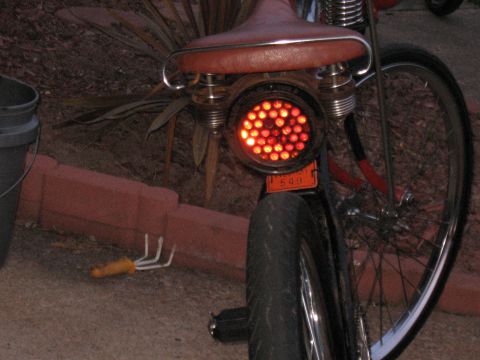 1994 Ford Bronco - A custom motorcycle features a unique tail light with numerous red LEDs and a small orange plate with the number 649.
