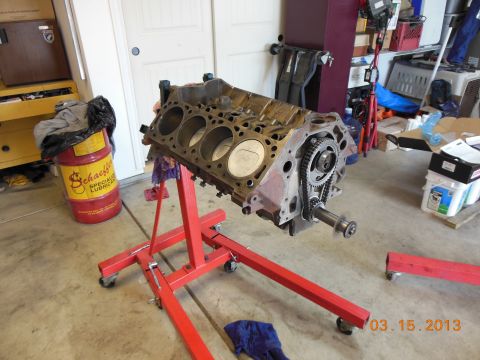 1979 Ford F-150 - Engine block on a stand in a garage setting, with a Schaeffer's oil drum nearby.