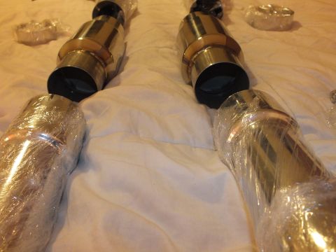 2003 Ford Crown Victoria - Detail of stainless exhaust tubing ends with black ball sockets and gold-tone slip collars