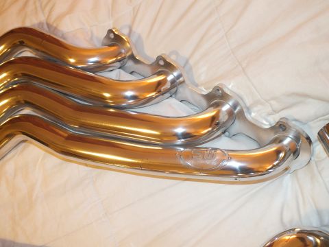 2003 Ford Crown Victoria - Stainless header tubes converging to a flange marked with an SW maker logo