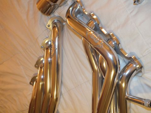 2003 Ford Crown Victoria - Pair of mirror-polished headers showing curved primary tubes and stamped flanges