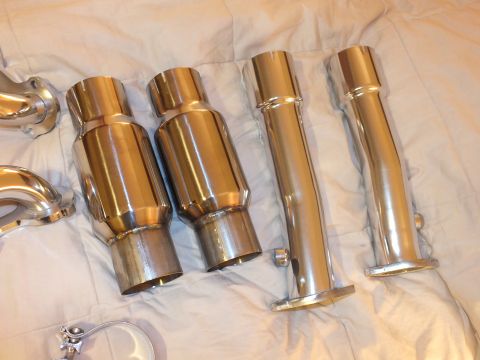 2003 Ford Crown Victoria - Four polished stainless exhaust tips and two flanged connector pipes laid out