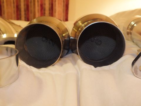 2003 Ford Crown Victoria - Two stainless exhaust outlets with black perforated mesh inserts viewed end-on