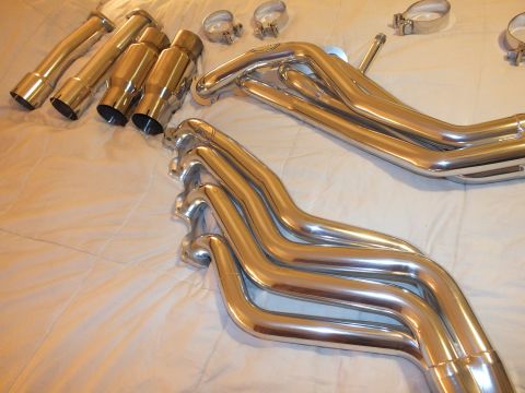 2003 Ford Crown Victoria - Polished header tubes, dual exhaust tips and several band clamps laid out together