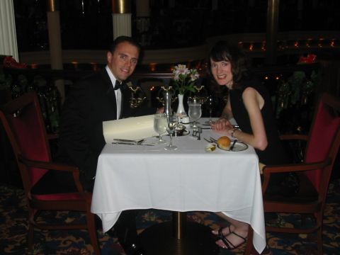 1992 Ford Bronco - A couple dressed in formal attire enjoys a meal at a candlelit table in a restaurant.