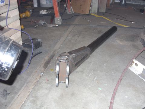 1967 Ford F-250 - A custom-fabricated metal component, possibly for a vehicle or machinery, is shown in a workshop setting.