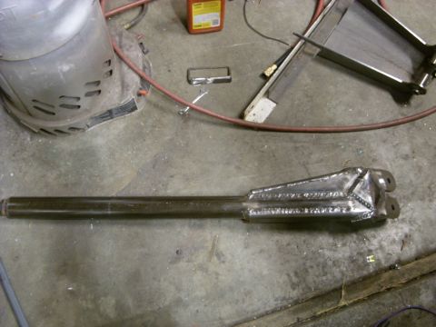 1967 Ford F-250 - A custom-fabricated suspension part, likely for a truck, is shown on a workshop floor.