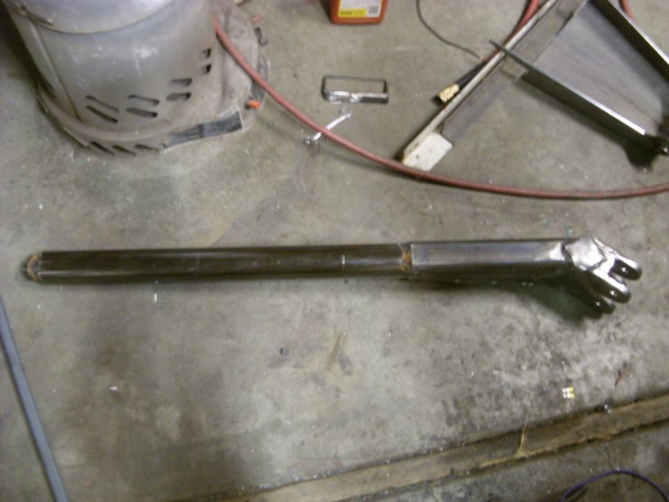 Custom metal tube with a multi-pronged end, likely a fabricated part for a vehicle or machinery