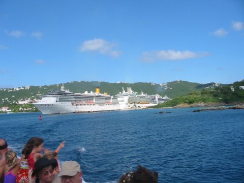 1992 Ford Bronco - Several cruise ships are docked in a bay near a tropical island, with people visible on a smaller boat in the foreground.