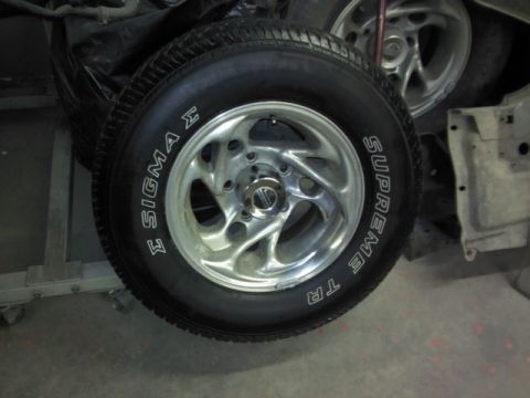 1967 Ford F-100 - Close-up of a chrome wheel with a Sigma Supreme TR tire, part of a vehicle registry photo.
