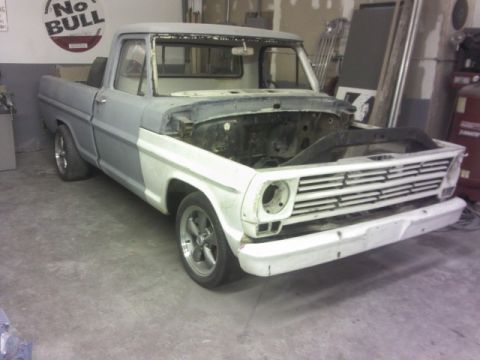 1967 Ford F-100 - This 1967 Ford F-100 pickup truck is undergoing restoration in a garage.