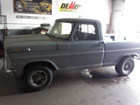 1967 Ford F-100 - A gray 1967 Ford F-100 pickup truck is parked inside a garage with a primer finish.