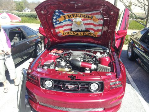 1965 Ford Mustang - Custom painted hood on a red Ford Mustang features an eagle and American flag with text.