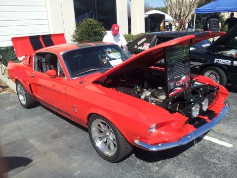 1965 Ford Mustang - This 1967 Shelby GT500 Mustang is displayed with its hood and trunk open at a car show.