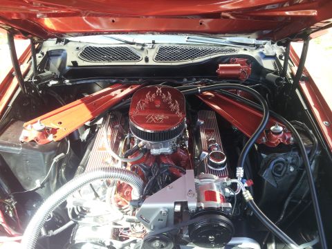 1965 Ford Mustang - Close-up of a modified V8 engine bay, polished components and custom detailing.