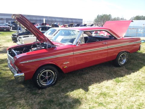1965 Ford Mustang - 1964 Ford Falcon Sprint coupe on display at a car show, hoods open.