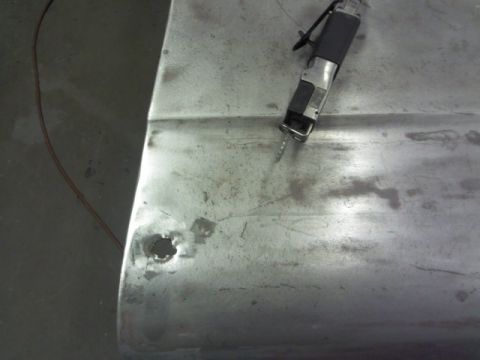 1967 Ford F-100 - A reciprocating saw is used to cut a hole in a bare metal panel.