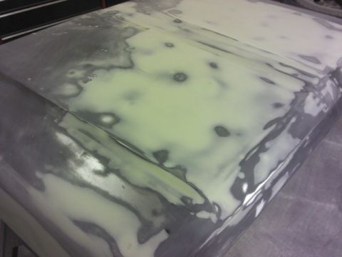 1967 Ford F-100 - Vehicle hood undergoing body repair with visible filler and primer.