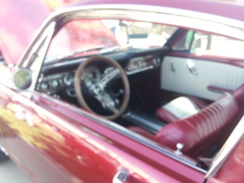 1965 Ford Mustang - Interior view of a 1965 Ford Mustang, red upholstery and a classic dashboard layout.