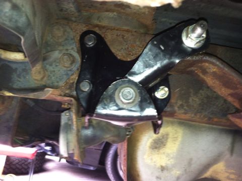 1996 Ford Bronco - A new spring hanger bracket is installed on the undercarriage of a vehicle.