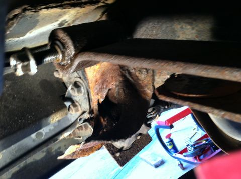 1996 Ford Bronco - Close-up of a heavily corroded spring hanger bracket, indicating a need for replacement on a 1996 Ford Bronco.