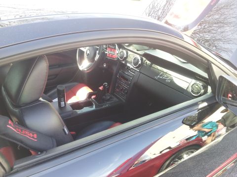 1965 Ford Mustang - Interior view of a car with racing seats and a custom dashboard signature.