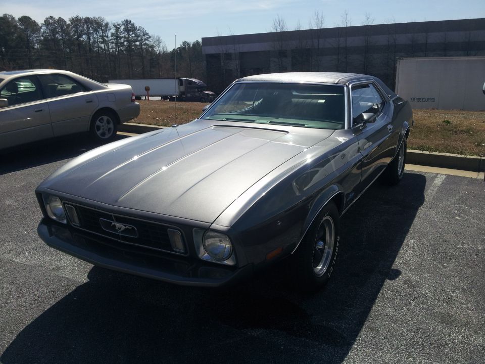 Gray 1971 Ford Mustang coupe parked in a lot, front three-quarter view