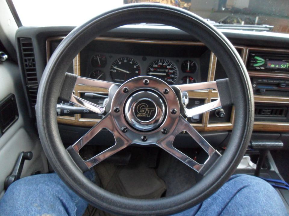1994 Jeep Cherokee interior with aftermarket Grant steering wheel and wood trim dashboard