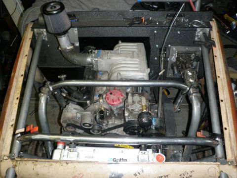 1961 International Scout 800 - Custom engine bay modifications include a supercharger and a Griffin radiator, with a visible roll cage structure.