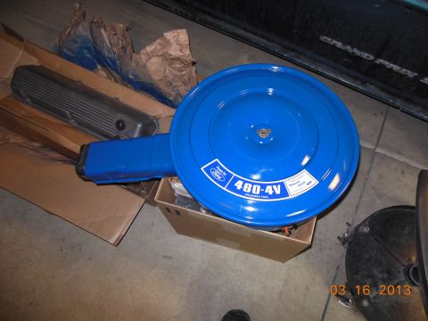 1979 Ford F-150 - A blue Ford air cleaner assembly and a silver valve cover are shown, possibly for a rebuild project.