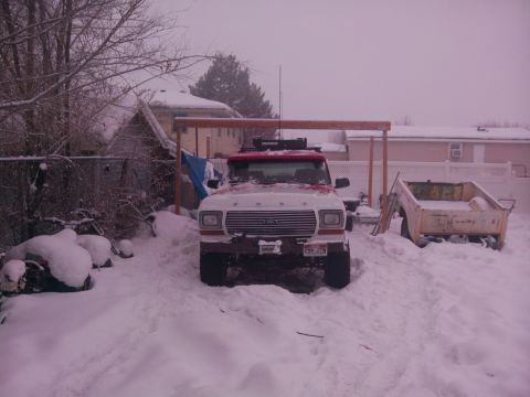 1979 Ford Bronco - 1978 Ford Bronco with roof rack in snowy conditions, other vehicles present.