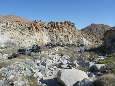 1997 Ford Ranger - Multiple trucks are visible in a wide shot of a , arid landscape.