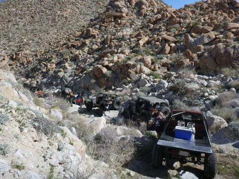 1997 Ford Ranger - An off-road vehicle tackles a challenging rocky path in a desert landscape.