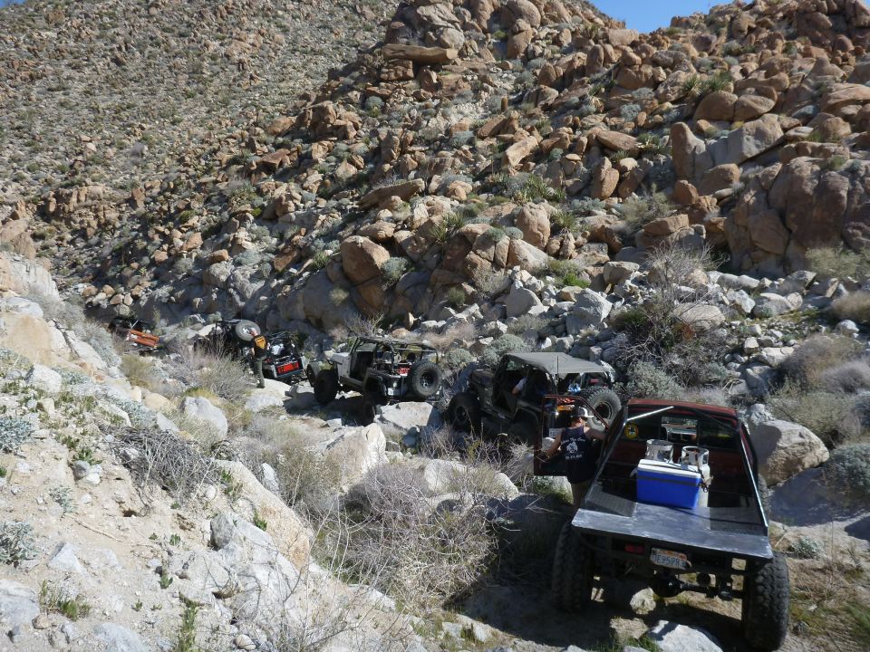 Off-road vehicle navigating a rocky, uphill trail
