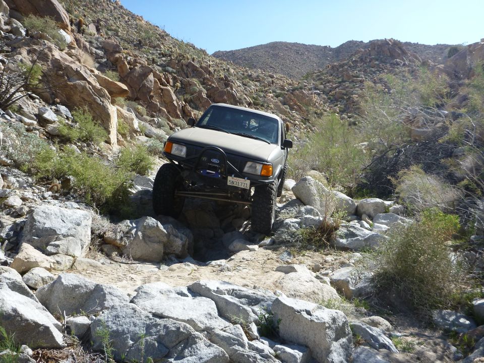Ford Ranger climbing over rocks on a desert trail
