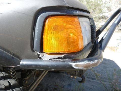 1997 Ford Ranger - The front corner of a dark-colored truck is visible, an aftermarket bumper and off-road lights.