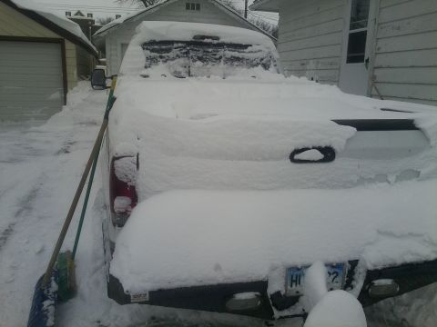 2000 Ford F-250 - Pickup truck buried in snow after a winter storm, parked in a driveway.