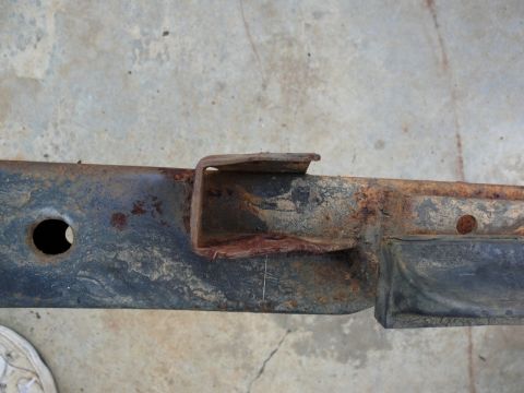 1976 Chevrolet Corvette - A close-up view of a corroded vehicle frame component shows significant rust and wear.