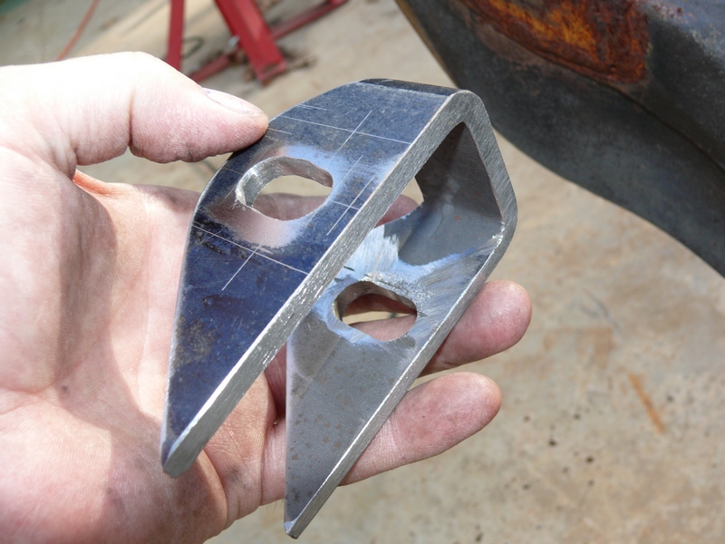 Metal bracket with two holes held in hand, Supermotors.net logo visible