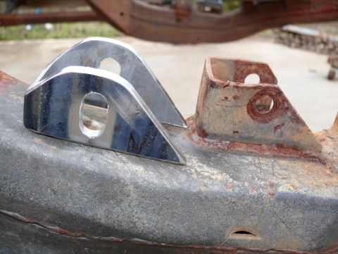 1976 Chevrolet Corvette - Newly fabricated suspension components are attached to a heavily rusted chassis. The SuperMotors logo is visible at the bottom right.