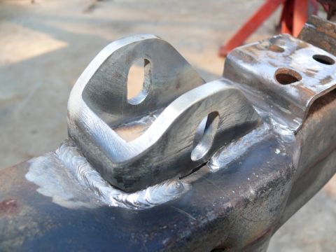 1976 Chevrolet Corvette - Close-up of a welded metal bracket with two holes, likely a component of a vehicle's frame or suspension system.