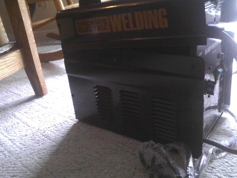 2003 Ford Crown Victoria - A Chicago Electric welding machine is shown indoors on a carpeted floor.