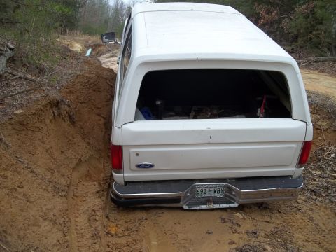 1990 Ford Bronco - This 1990 Ford Bronco is stuck in a muddy rut on an unpaved road.