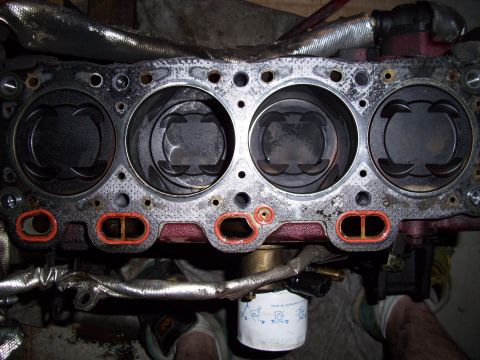 1995 Ford Probe - Close-up view of an engine block's cylinders and pistons.
