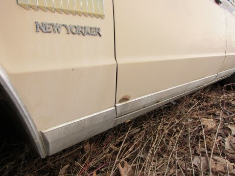 1991 Ford LTD Crown Victoria - Close-up of the 'New Yorker' emblem on a car's side panel.